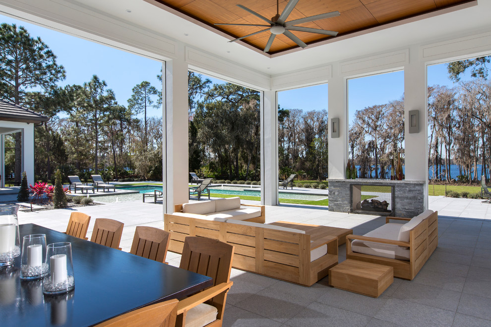Inspiration for a contemporary back patio in Orlando with a fire feature and a roof extension.
