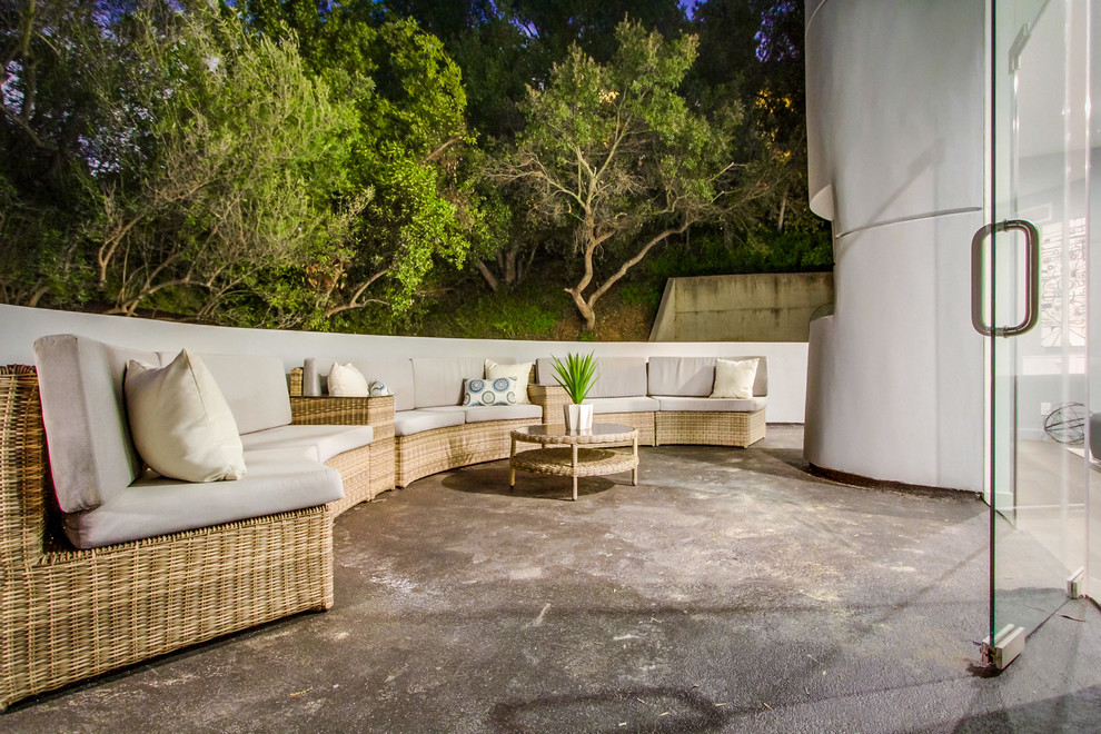 Inspiration for a contemporary back patio in Other with concrete slabs and no cover.