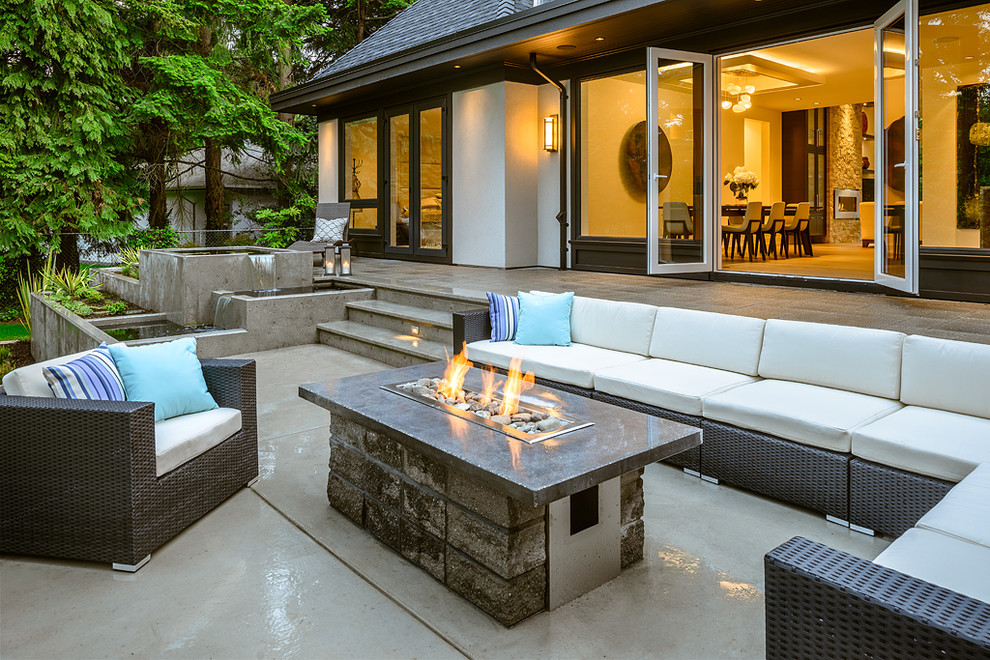 This is an example of a contemporary patio in Vancouver with a fire feature.