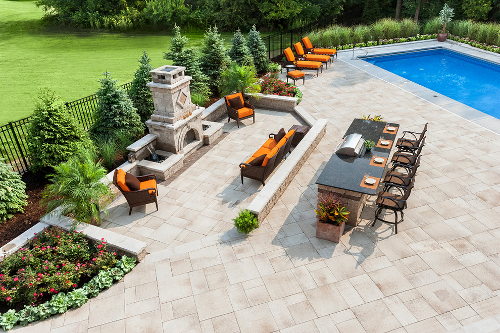 Large contemporary back patio in Chicago with a water feature, brick paving and no cover.