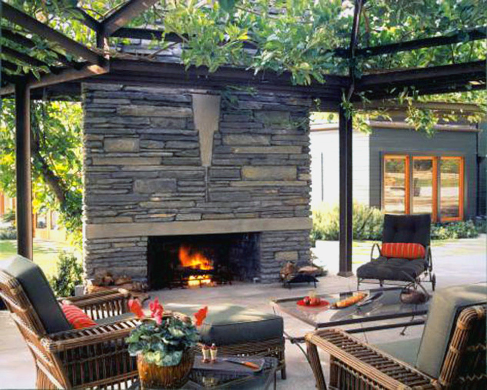 Photo of a contemporary patio in Los Angeles with a fire feature and a pergola.