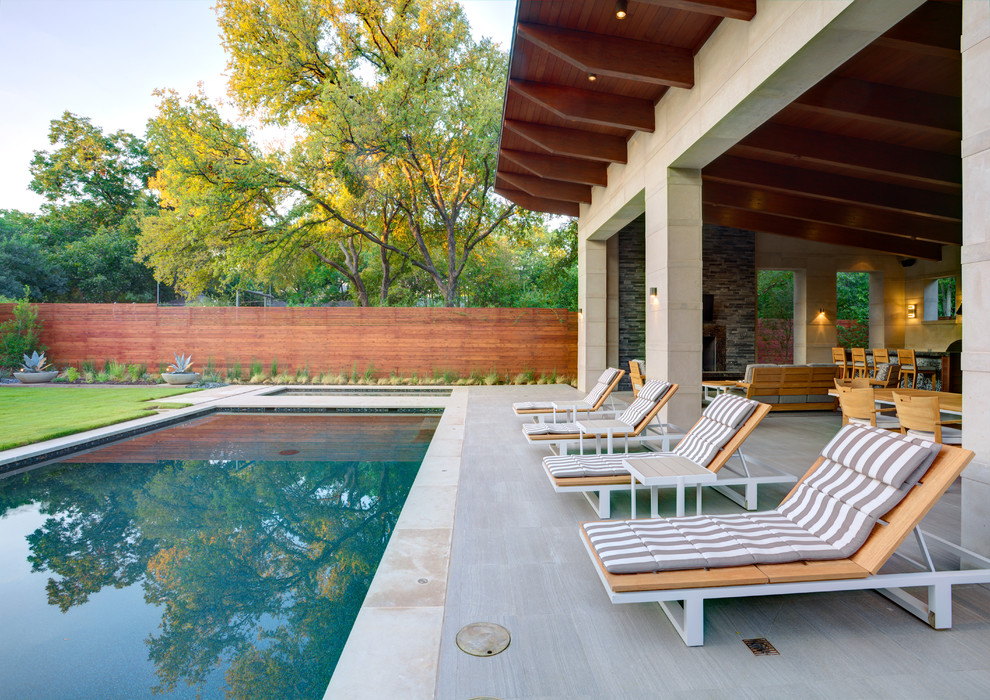 Contemporary patio in Dallas with a fire feature and a roof extension.