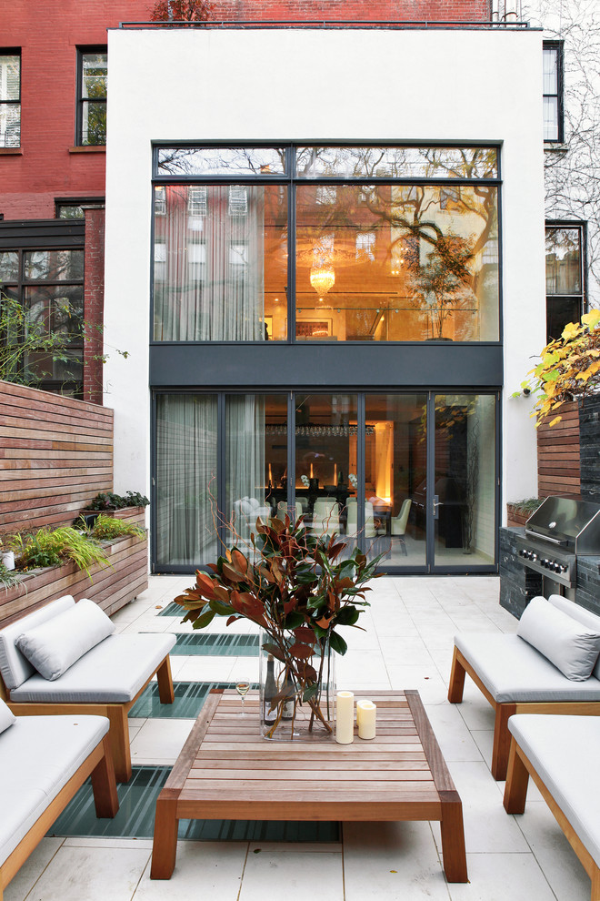 Photo of a contemporary back patio in New York with an outdoor kitchen and no cover.