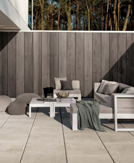 Contemporary patio with grey stone look porcelain tile floors