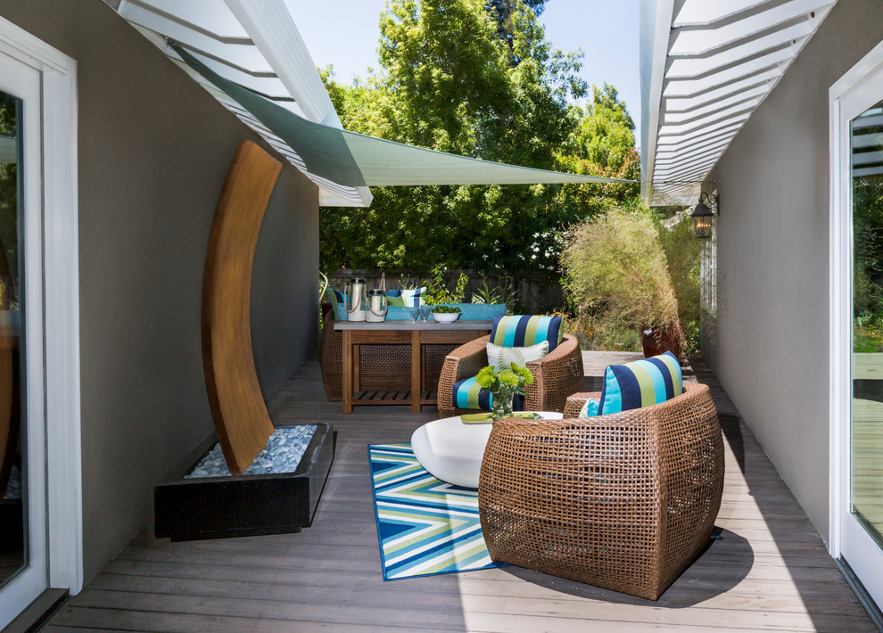 Small transitional courtyard patio photo in San Francisco with decking and an awning