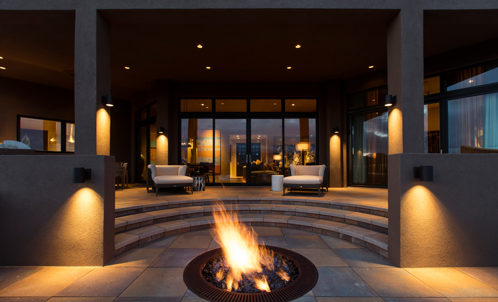 Contemporary patio in Albuquerque with a fire feature and a roof extension.