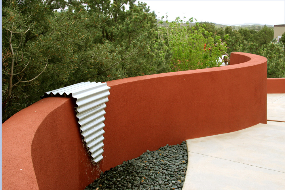 Inspiration for a contemporary front patio in Albuquerque with a water feature.