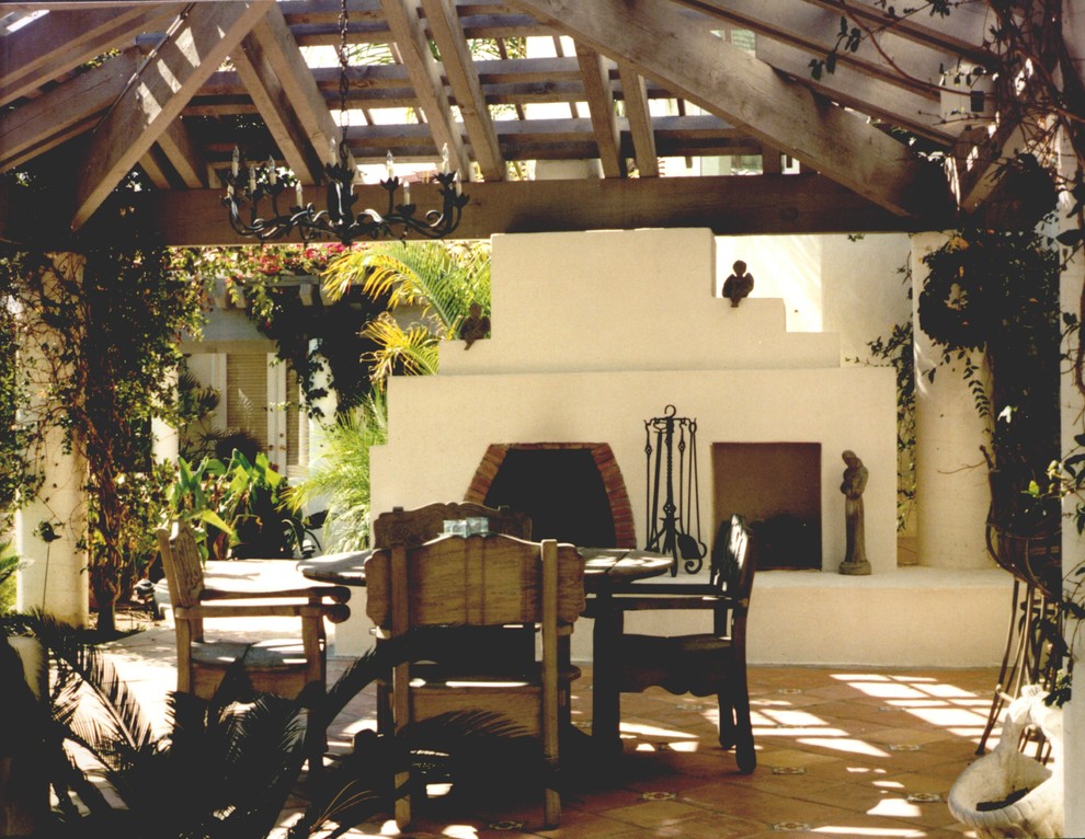 Idée de décoration pour une terrasse arrière sud-ouest américain de taille moyenne avec un foyer extérieur, du carrelage et une pergola.