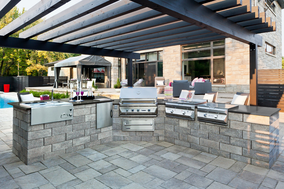 Example of a mid-sized trendy backyard patio kitchen design in Other