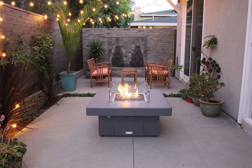 Inspiration for a small contemporary back patio in Santa Barbara with a fire feature, concrete slabs and no cover.