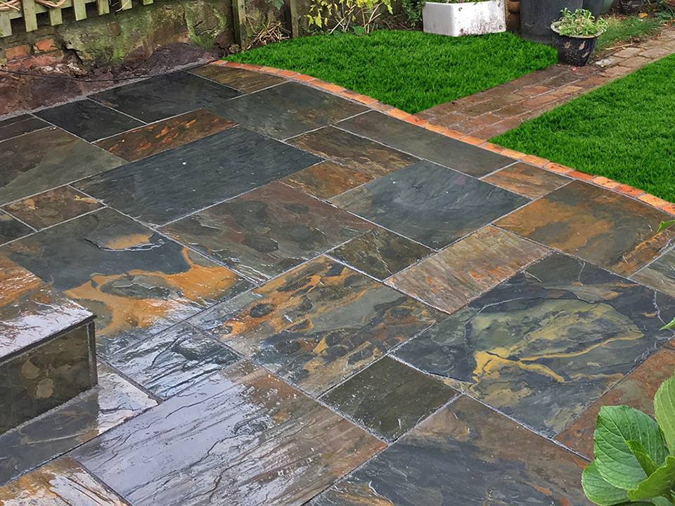 This is an example of a small traditional back patio in West Midlands with natural stone paving.