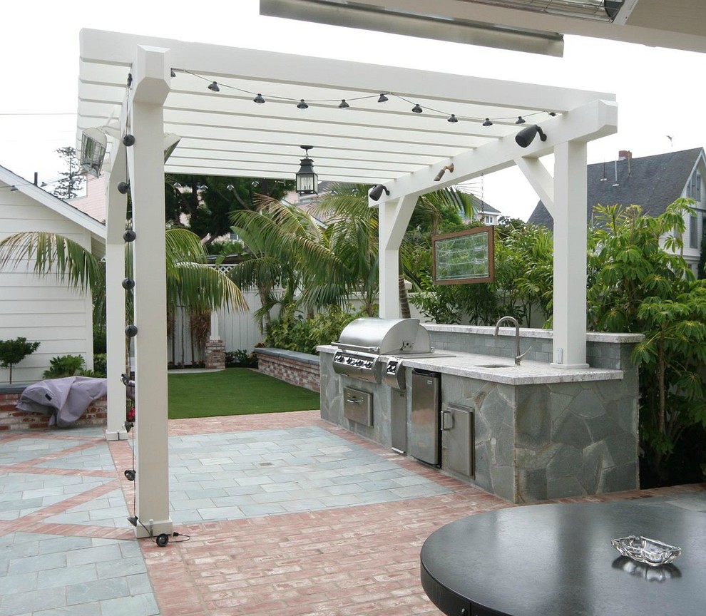 Medium sized bohemian back patio in San Diego with an outdoor kitchen, brick paving and a pergola.