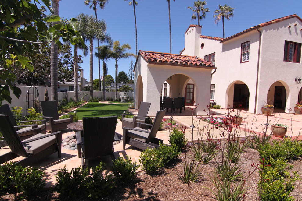 Medium sized mediterranean courtyard patio in San Diego with a fire feature, tiled flooring and no cover.