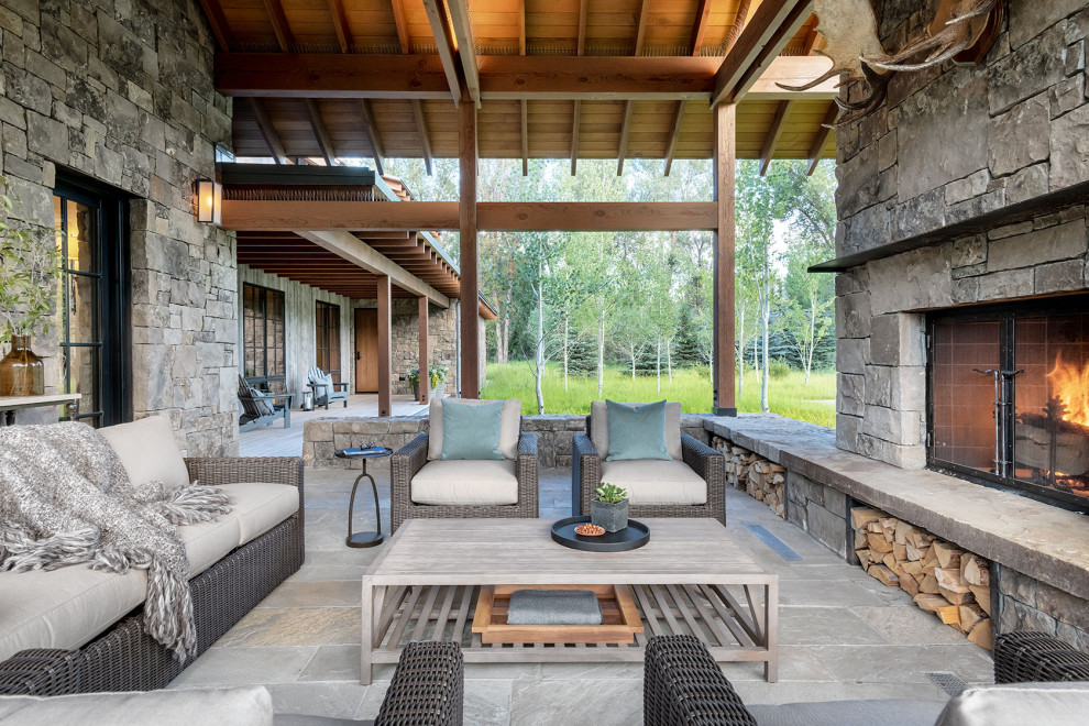 Diseño de patio de estilo de casa de campo en anexo de casas con chimenea