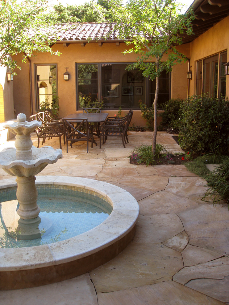 Photo of a mediterranean courtyard patio in San Francisco with a water feature.
