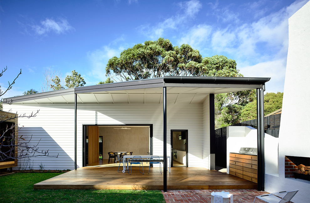 Inspiration for a medium sized contemporary courtyard patio in Melbourne with a fire feature, decking and a pergola.