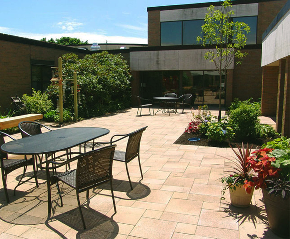 Large traditional courtyard patio in Providence with a potted garden, concrete paving and no cover.