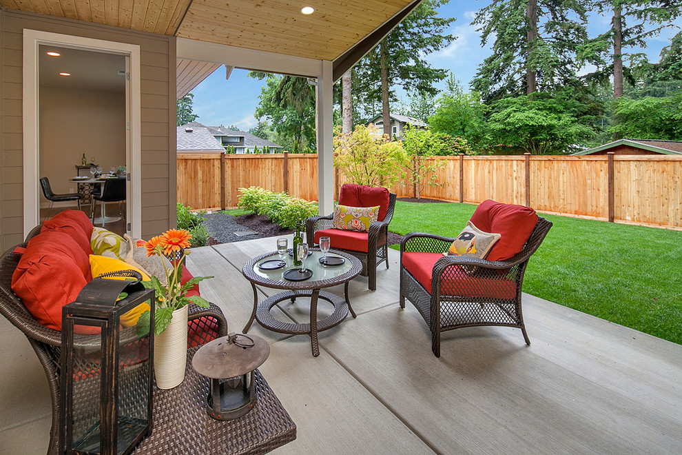 Patio - craftsman backyard concrete patio idea in Seattle with a roof extension