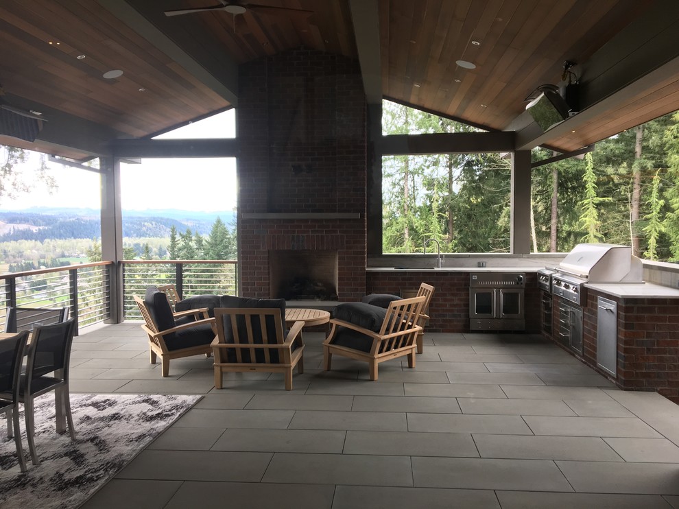 Design ideas for a large classic back patio in Seattle with an outdoor kitchen, concrete paving and a gazebo.