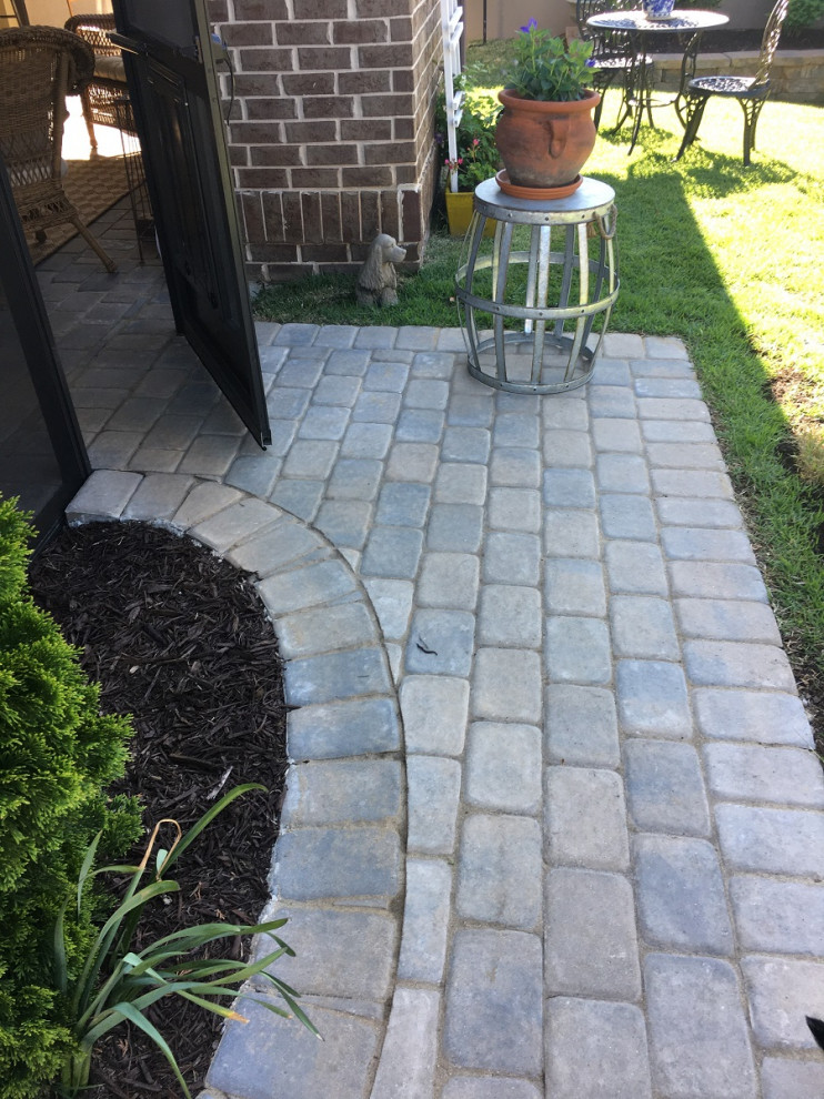 Design ideas for a small eclectic back patio in Other with brick paving.