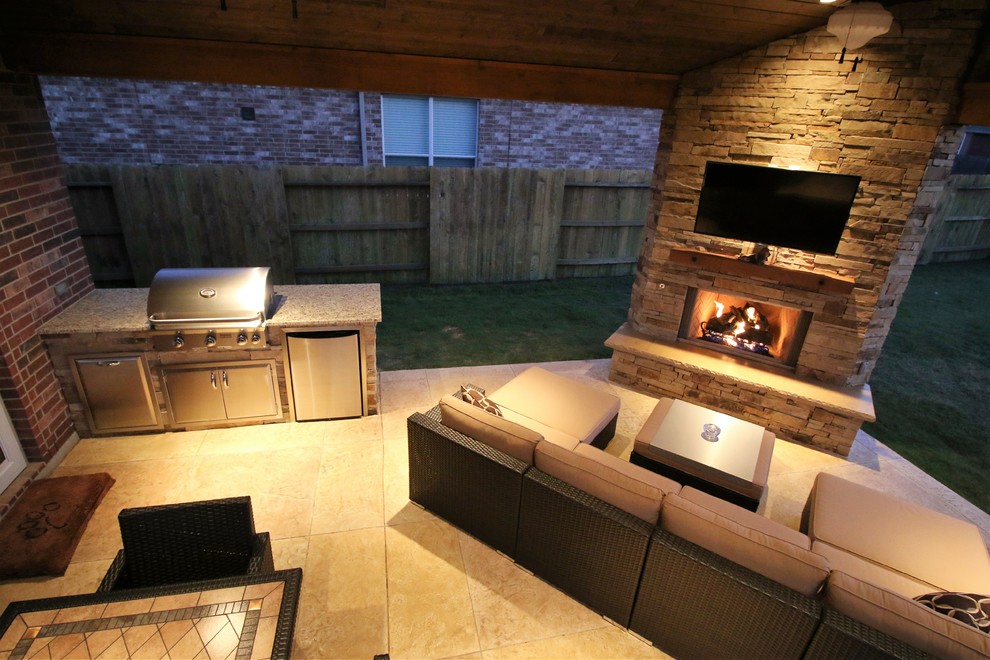 Inspiration for a classic back patio in Houston with a fire feature, stamped concrete and a roof extension.