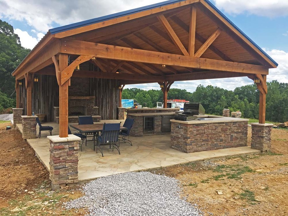 Covered pavilion with outdoor kitchen and fireplace before the