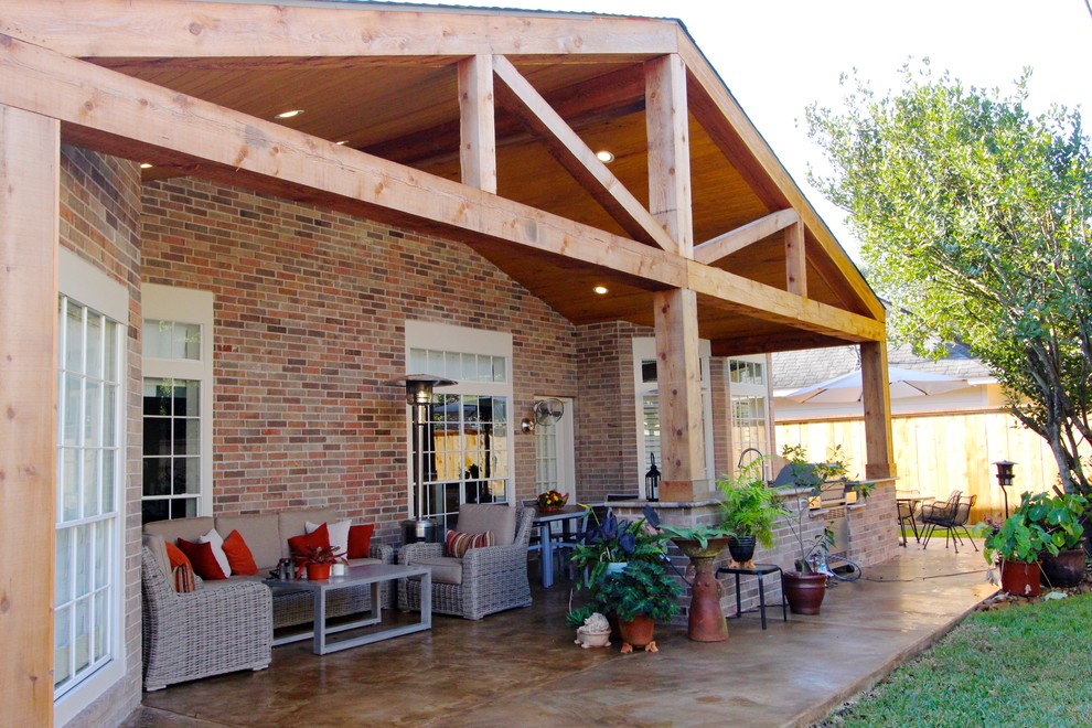 Inspiration for a rustic backyard patio kitchen remodel in Houston with a roof extension