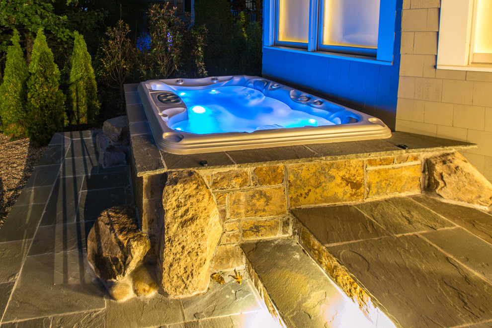 Inspiration for a small craftsman backyard stone patio fountain remodel in Charlotte
