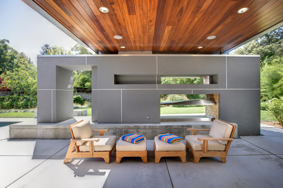 Esempio di un patio o portico minimalista con un tetto a sbalzo
