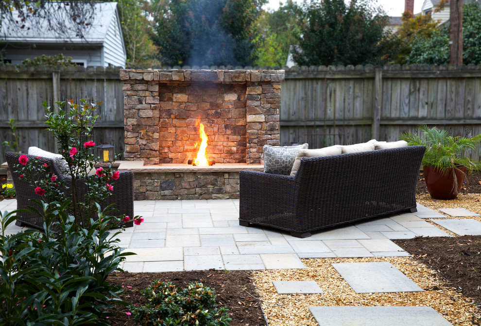 This is an example of a medium sized traditional back patio in Richmond with a fire feature, concrete paving and no cover.