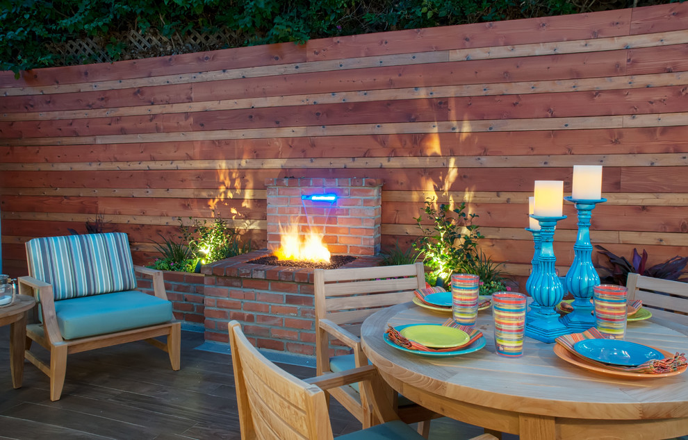 Mid-sized beach style backyard tile patio photo in San Diego with a fire pit and no cover