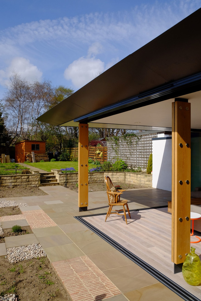 Example of a trendy patio design in Edinburgh with a roof extension