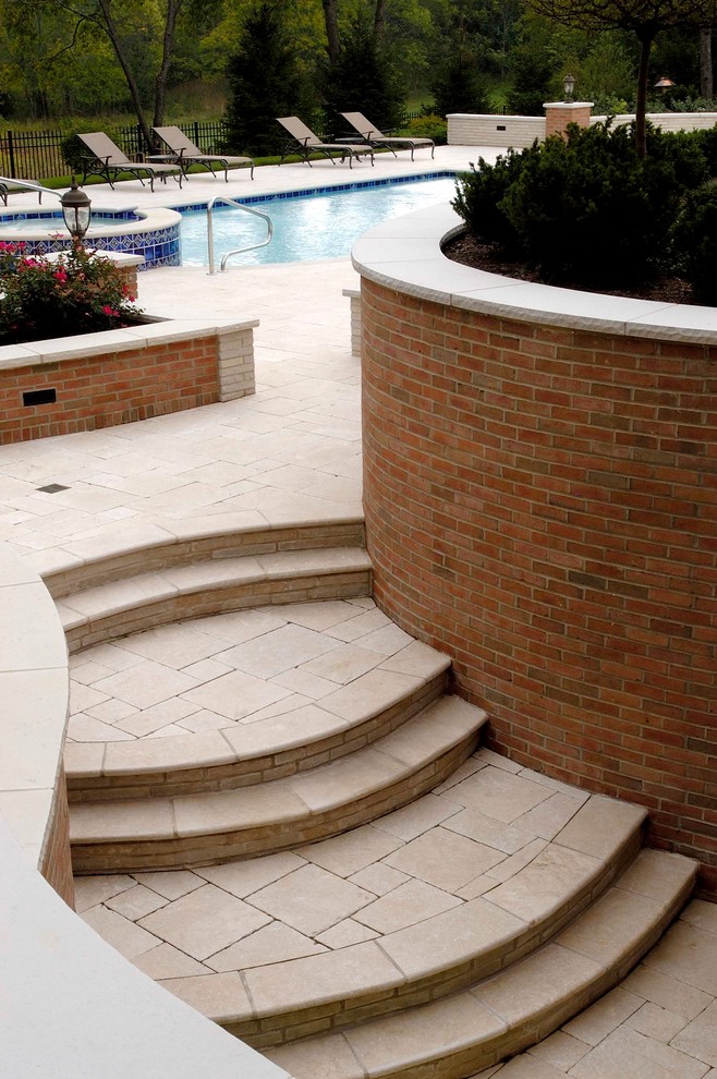Expansive classic back patio in Chicago with natural stone paving.