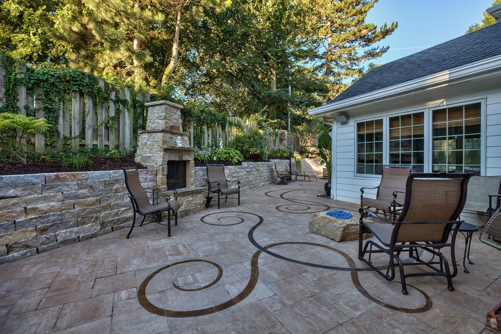 Design ideas for a medium sized bohemian back patio in Omaha with a fire feature and concrete paving.