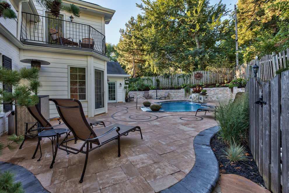 Inspiration for a mid-sized eclectic backyard concrete paver patio fountain remodel in Omaha