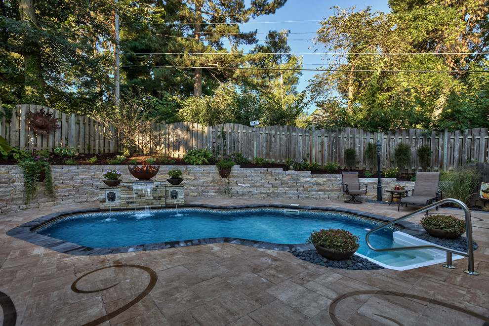Example of a mid-sized eclectic backyard concrete paver pool fountain design in Omaha