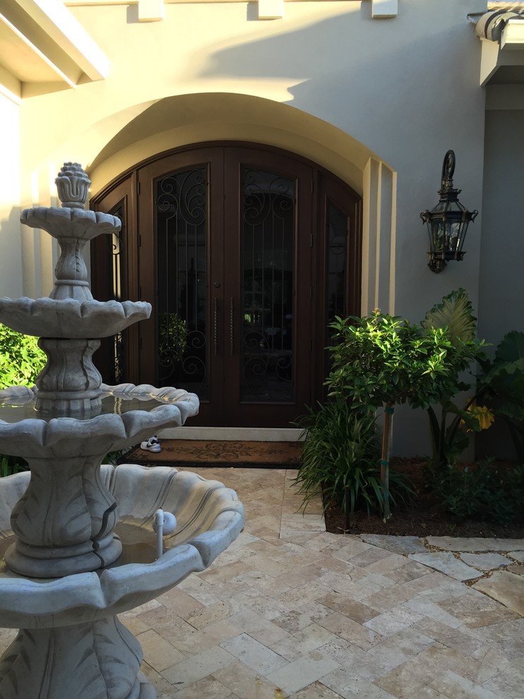 Inspiration for a mid-sized timeless side yard stone patio fountain remodel in Cincinnati with no cover