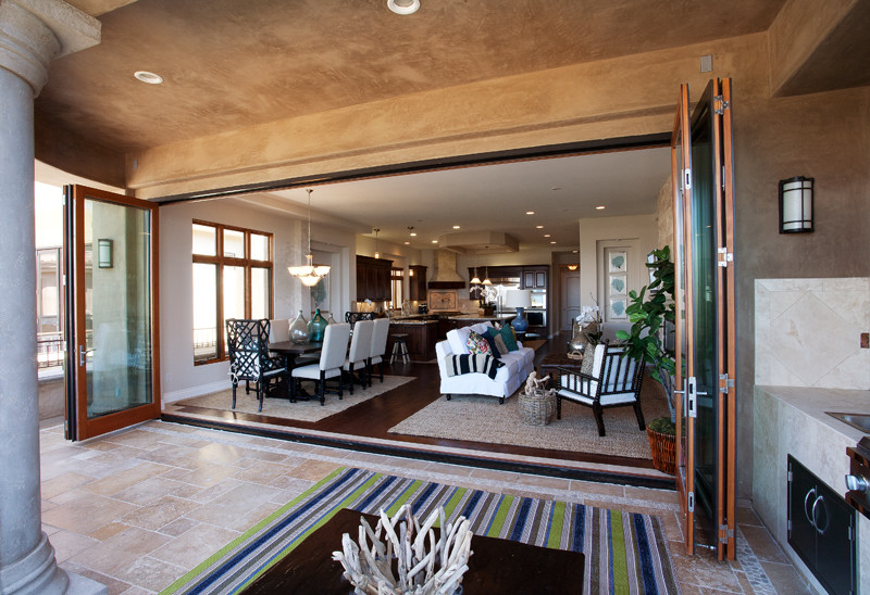 Large tuscan backyard stone patio kitchen photo in San Diego with a roof extension