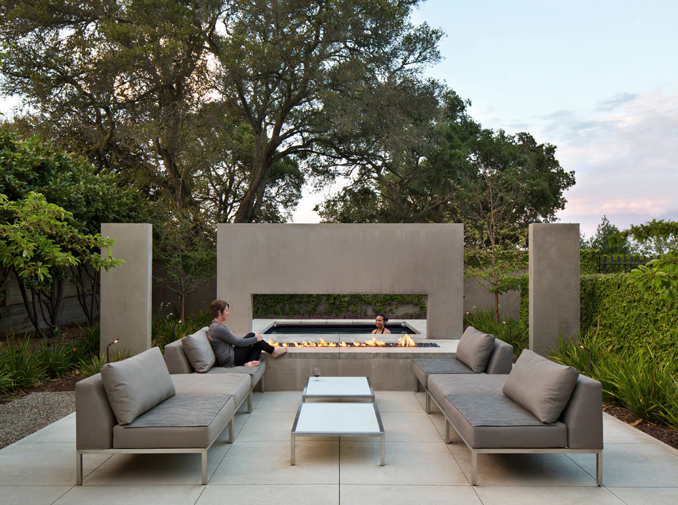 На фото: двор в стиле модернизм с местом для костра без защиты от солнца