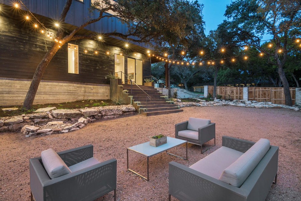Photo of a classic back patio in Austin with gravel.