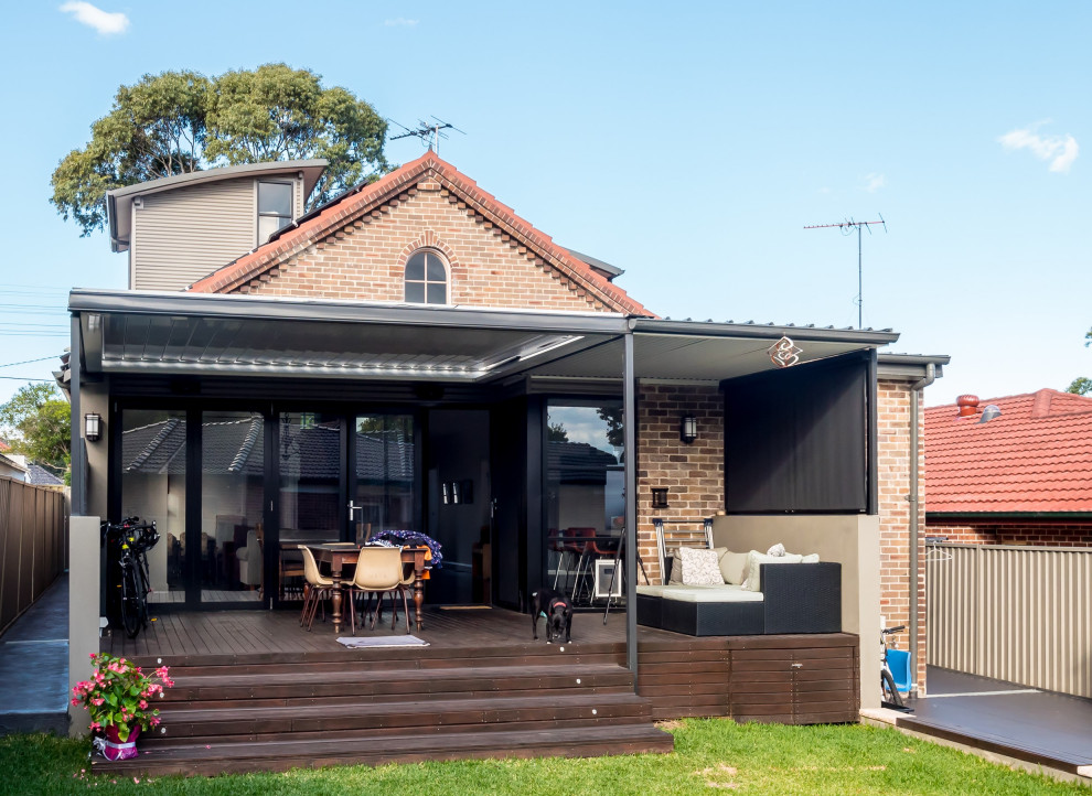 Medium sized contemporary back patio in Sydney with decking and a pergola.