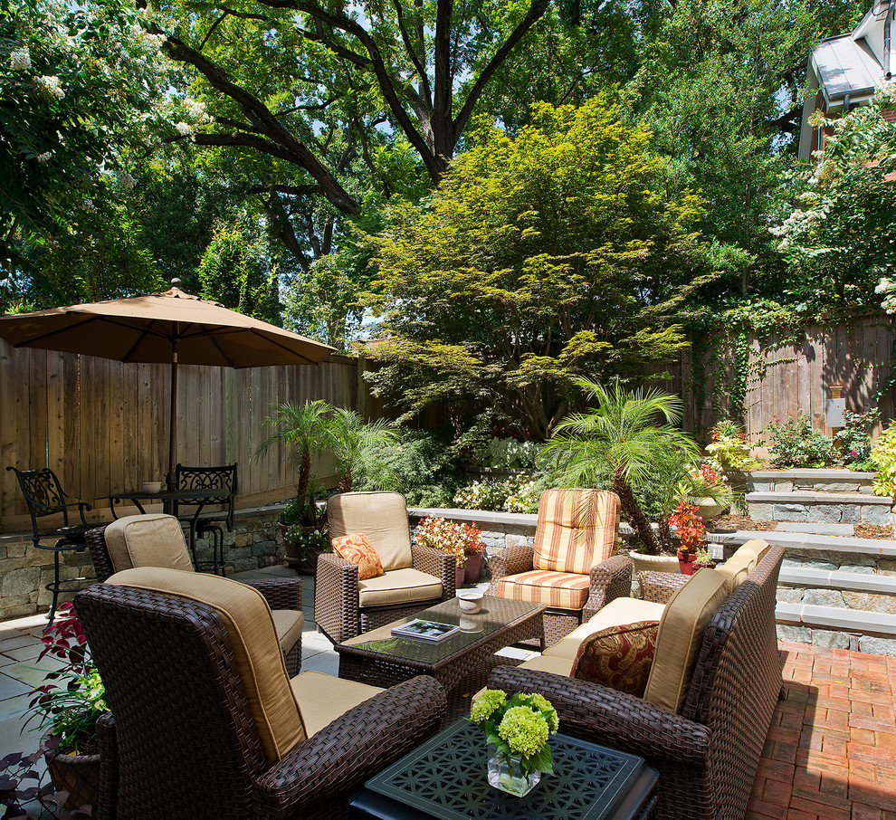 Mid-sized eclectic backyard stone patio photo in DC Metro with no cover
