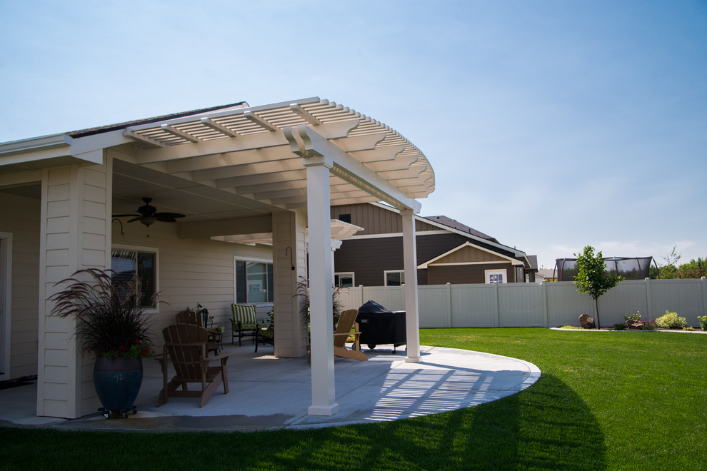 Design ideas for a classic back patio in Boise with a pergola.