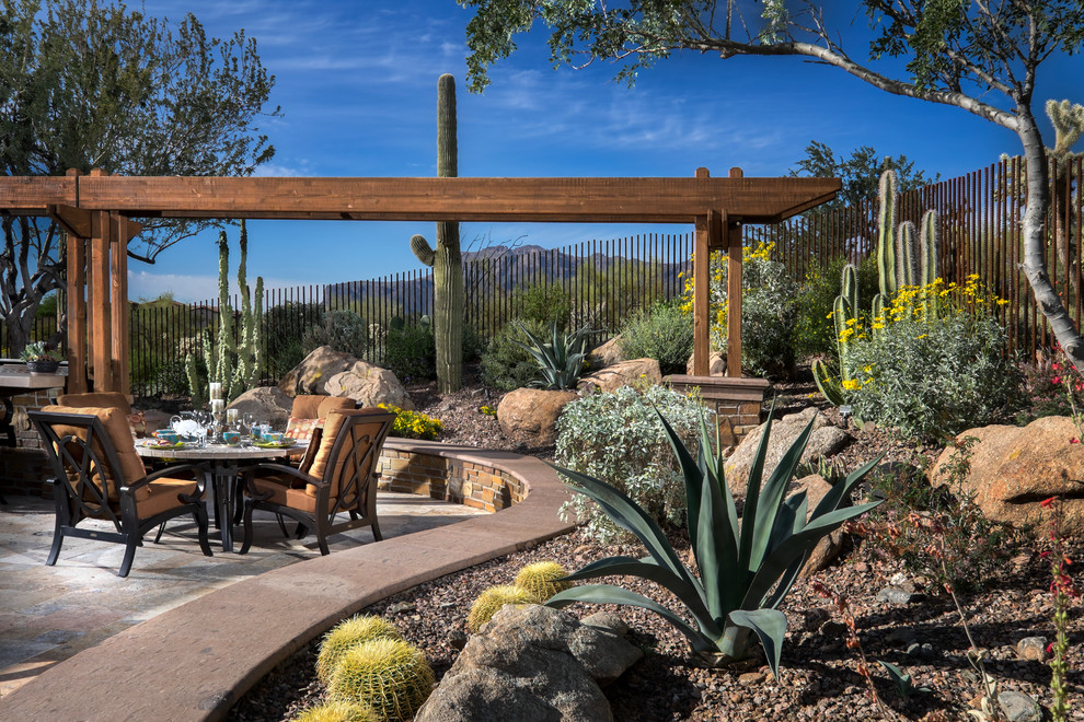 Design ideas for an expansive back patio in Phoenix with a fire feature, natural stone paving and a pergola.