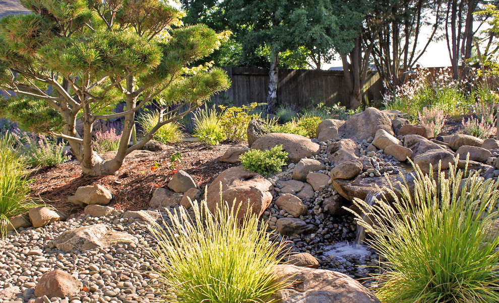 Inspiration for a mid-sized contemporary partial sun backyard gravel water fountain landscape in Other for summer.