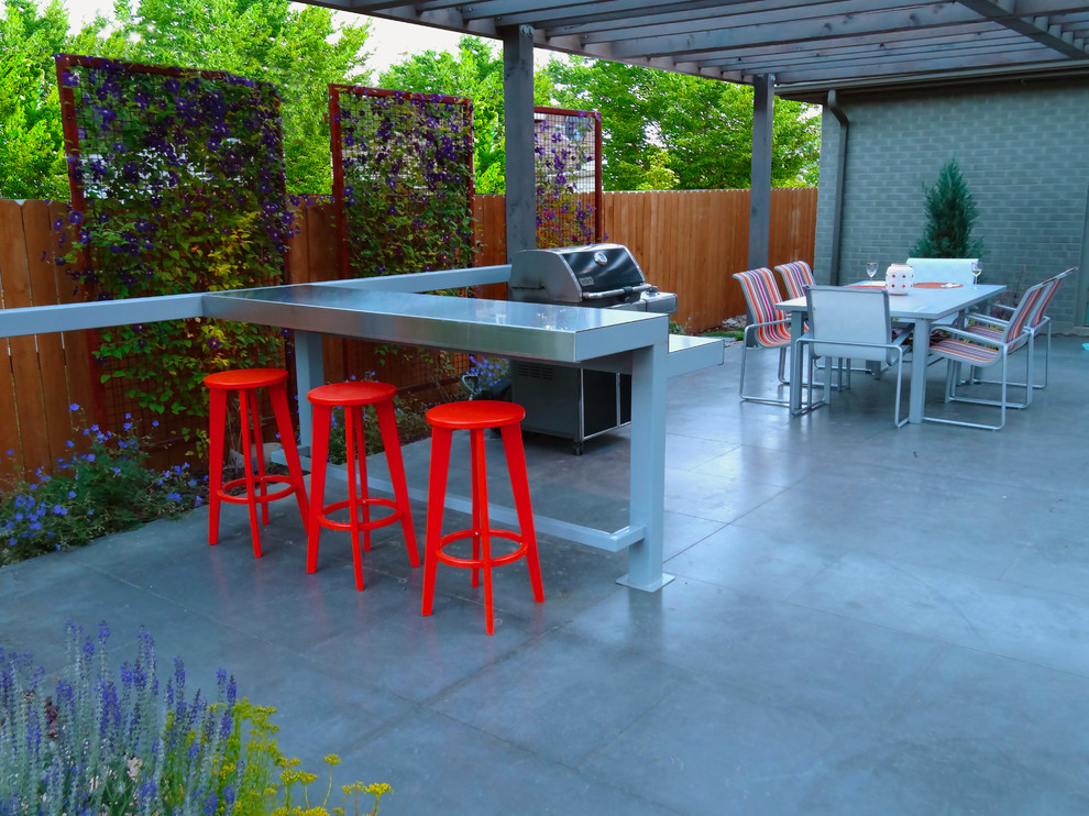 Inspiration for a modern back patio in Denver with an outdoor kitchen, stamped concrete and a pergola.