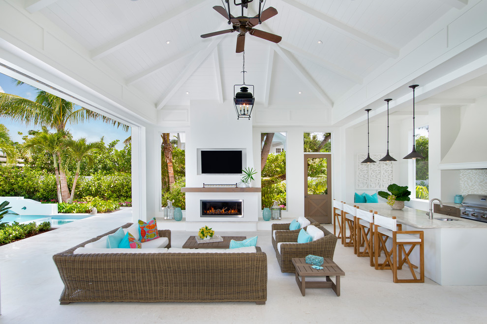Photo of a large beach style back patio in Other with an outdoor kitchen and a roof extension.