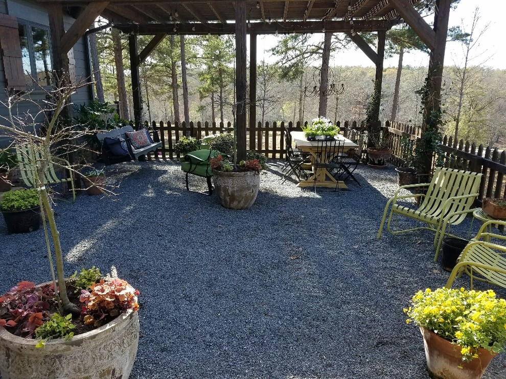 Inspiration for a mid-sized craftsman backyard gravel patio remodel in Atlanta with a pergola