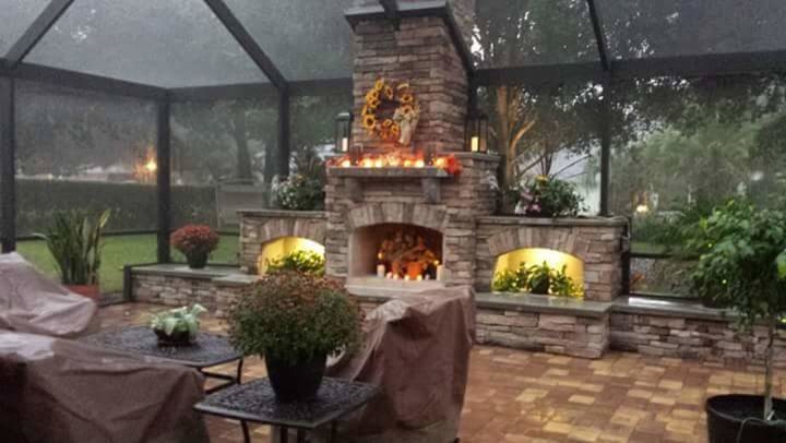 Inspiration for a large contemporary back patio in Other with a fire feature, brick paving and a gazebo.