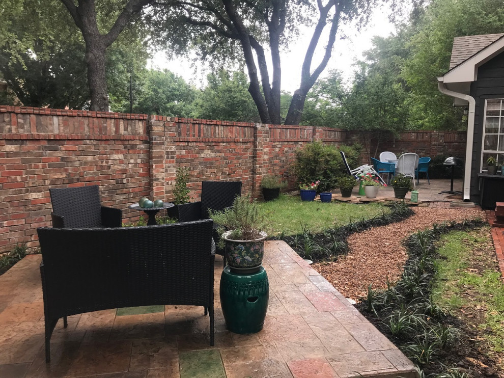 Inspiration for a mid-sized timeless backyard stamped concrete patio remodel in Dallas